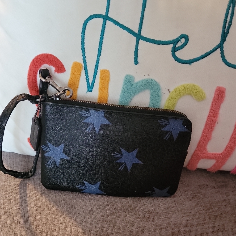 Coach Black Wristlet with Blue Star Design Strap Is Worn
